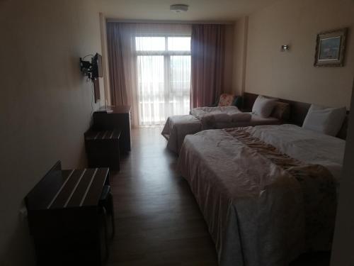 a hotel room with two beds and a couch at Balneo and SPA Complex MINERAL YAGODA in Yagoda