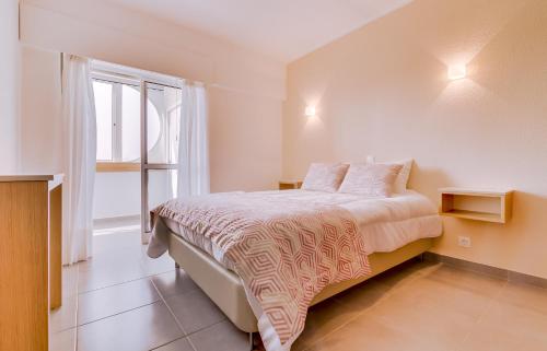a bedroom with a bed and a large window at Hope House - 1 Bedroom - Vilamoura in Vilamoura