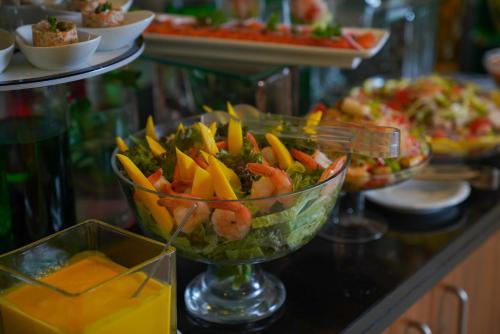 a salad with shrimp and vegetables in a bowl on a counter at Ramada Encore by Wyndham Kuwait Downtown in Kuwait