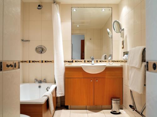 a bathroom with a sink, toilet and bathtub at Royal Hotel in Scarborough