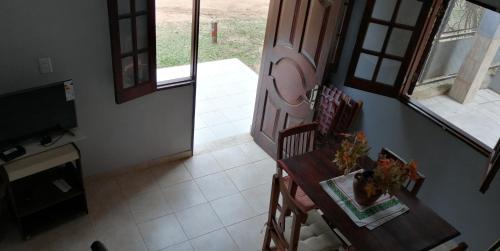 a dining room with a table and chairs and a television at Las Piedras del Paso in Paso de la Patria
