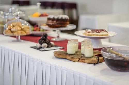 a table with cakes and other desserts on it at Aeolis Boutique Hotel in Naxos Chora