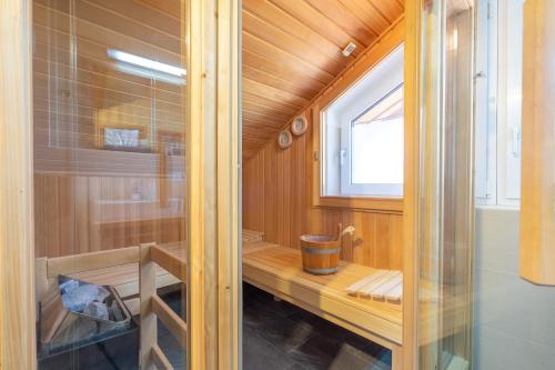 a bathroom with a sauna with a window at Chalet Gretl in Oberstdorf