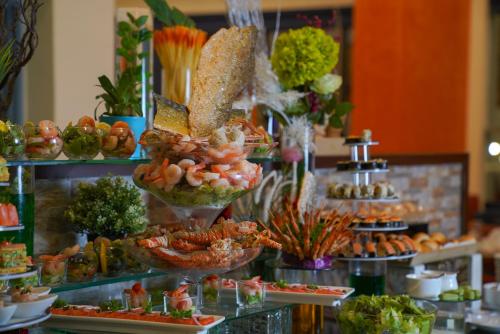 a buffet with many different types of food on display at Ramada Encore by Wyndham Kuwait Downtown in Kuwait