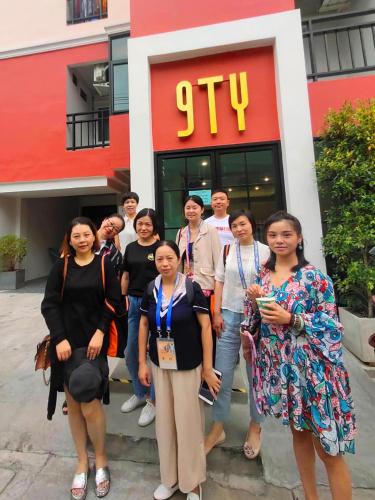 a group of people standing in front of a store at 9TY hotel (ninety hotel) in Bangkok