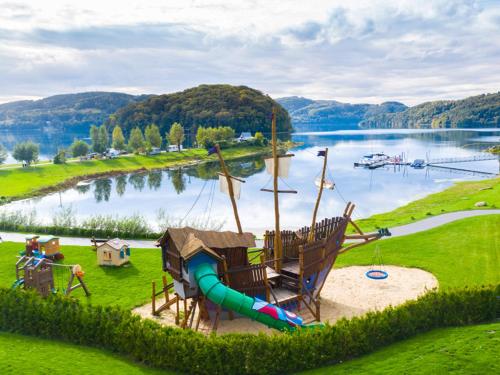 a playground with a slide and a water park at Lemon Resort Spa in Gródek Nad Dunajcem
