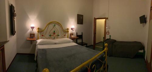 a hotel room with a bed and a chair at Hotel Ficocle in Cervia