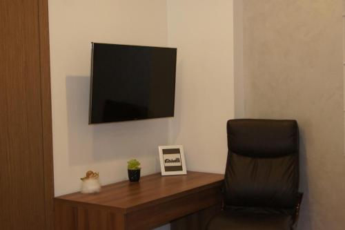 a room with a desk with a chair and a television at KOMFORT HOUSE RYNEK in Wrocław