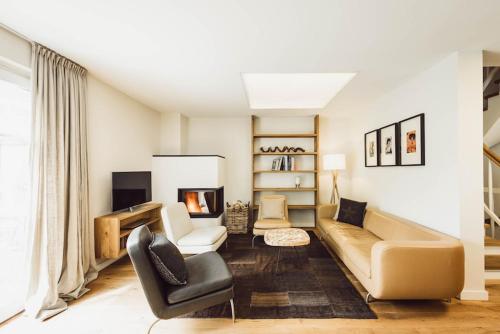 a living room with a couch and a fireplace at Chalet Stolz in Grossarl