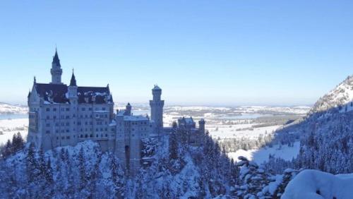 a castle in the snow on a mountain at Alpenmotel Säuling in Reutte