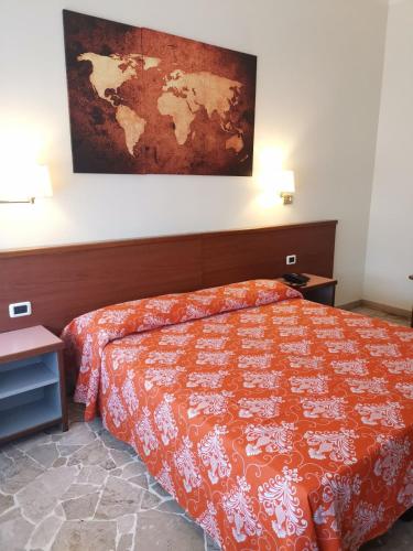 a bedroom with a bed and a map on the wall at H&L Hotel in Cinisello Balsamo