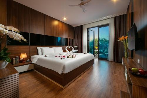 a bedroom with a large bed with flowers on it at Tam Coc Holiday Hotel & Villa in Ninh Binh