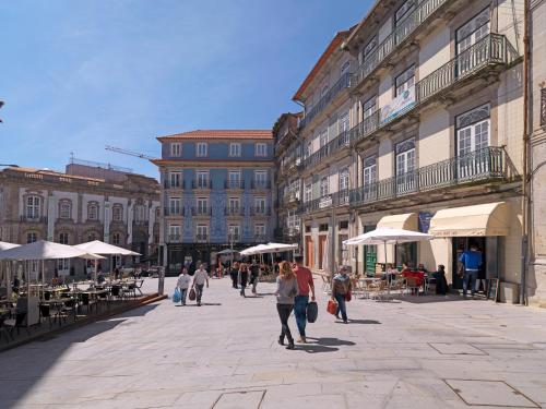 un grupo de personas caminando por una calle de la ciudad en FLH Porto Modern Rooftop, en Oporto
