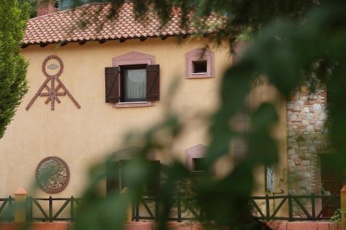 a house with a painting of a window and a star at Hotel Nemesis in Stavroupoli