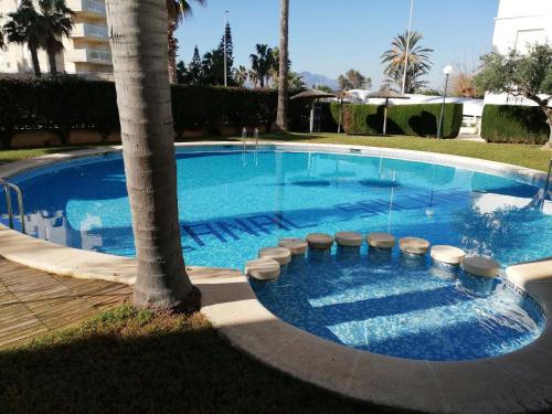 Bazén v ubytovaní CANCÚN III Solo Familias Serviplaya alebo v jeho blízkosti