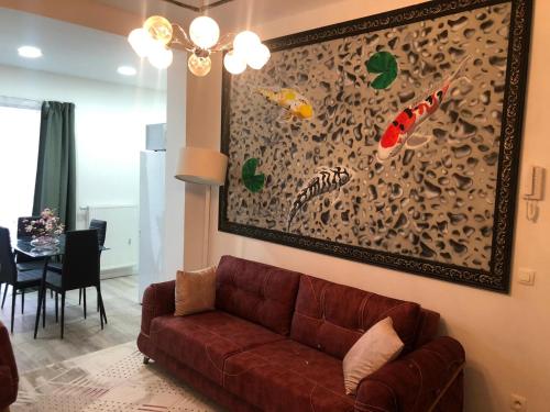 a living room with a couch and a painting on the wall at your home ! in Antwerp