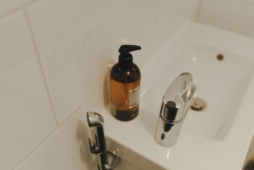 a bottle of soap sitting on top of a sink at Lillstugans Gästhem BnB in Vöyri