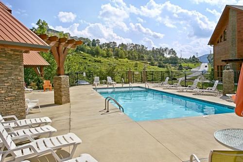 a swimming pool with lounge chairs at Southern State of Mind in Pigeon Forge