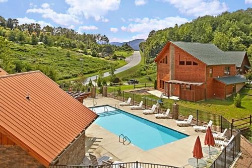 a house with a swimming pool next to a building at Southern State of Mind in Pigeon Forge