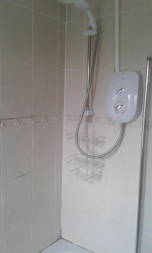 a bathroom with a shower with a sink and a toilet at Carvetii - Derwent House - Spacious 2nd floor flat in Grangemouth