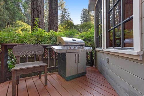 a grill on a deck with a bench on a porch at Terra in Monte Rio