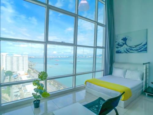 a room with a bed and a large window at Maritime Suites by Comfy in George Town