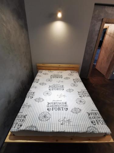 a bed in a room with a white mattress at Loft style apartments in the center in Sumy