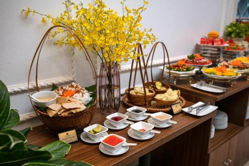 a buffet of food on a table with baskets of food at Tam Coc Holiday Hotel & Villa in Ninh Binh