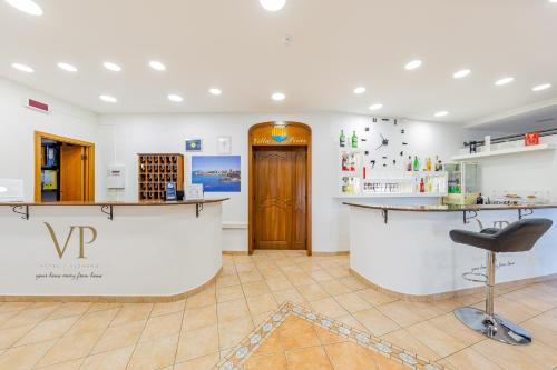 a kitchen with a sink and a refrigerator at Hotel Villa Piras in Alghero