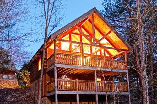 a large wooden house with a large deck at God's Grace in Pigeon Forge