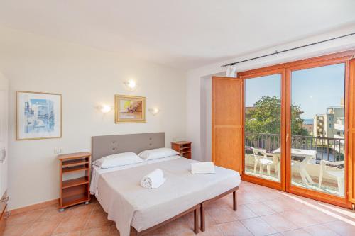 Cama ou camas em um quarto em Hotel Villa Piras