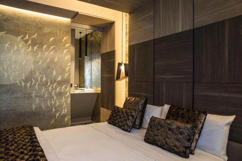 a hotel room with two beds and a mirror at Milestone in Quartu SantʼElena