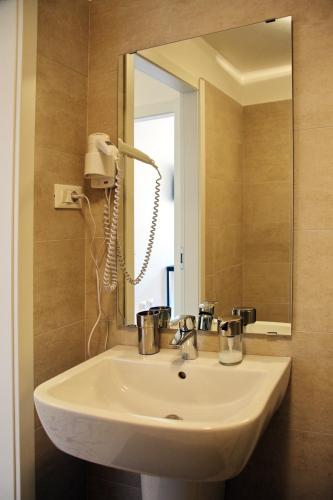 a white sink in a bathroom with a mirror at CLESIO 2 in Trento