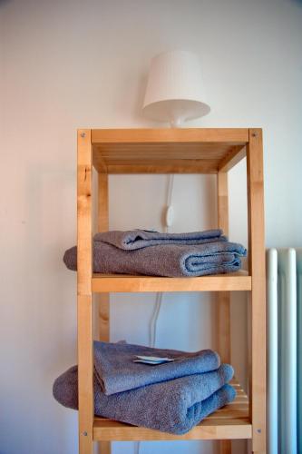 a wooden shelf with blue towels on it at CLESIO 2 in Trento
