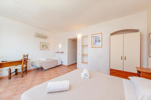 Ένα ή περισσότερα κρεβάτια σε δωμάτιο στο Hotel Villa Piras