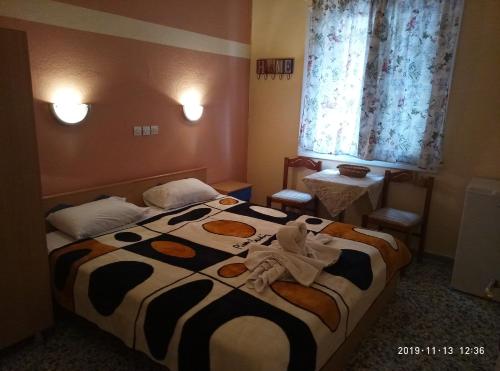 a bedroom with a bed with towels on it at Sofia Rooms in Loutra Edipsou