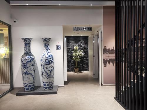 two blue and white vases on display in a hallway at cité impériale ye in Mettet