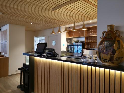 a kitchen with a bar with a laptop on top of it at cité impériale ye in Mettet