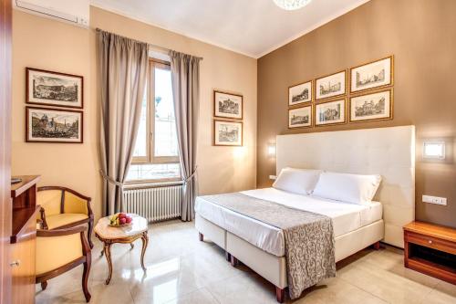 - une chambre avec un lit, un bureau et une fenêtre dans l'établissement La Residenza Suites, à Rome