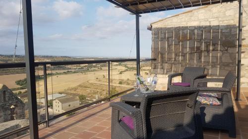 a balcony with a table and chairs and a view at Castell de Fonolleres in Fonolleres