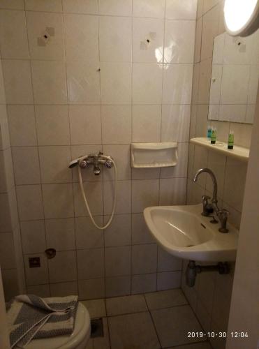 a bathroom with a sink and a toilet at Sofia Rooms in Loutra Edipsou