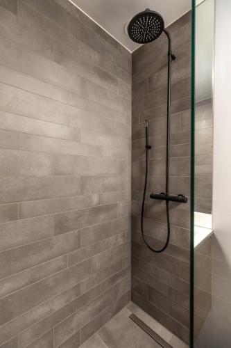 a bathroom with a shower with a glass door at Hilversum City Apartments in Hilversum