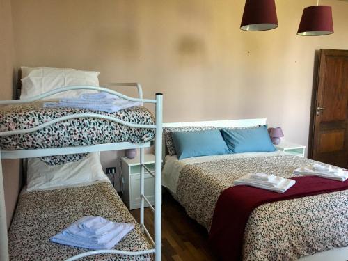 a bedroom with two bunk beds and a bed with towels at Villa Manto in Mantova