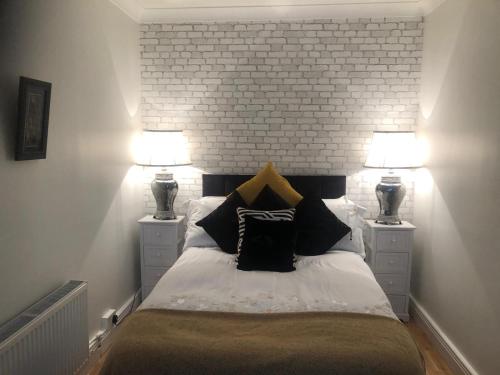a bedroom with a bed with two lamps on it at Beechtree House in Dublin