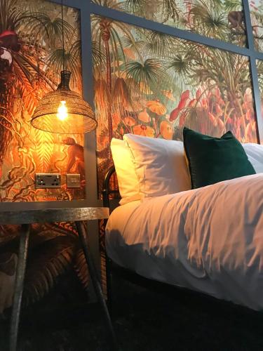a bedroom with a bed and a table with a wall mural at The Market House in Reading