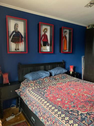 a bedroom with a bed with pictures on the wall at Gondola Flat Number 5 in Bansko