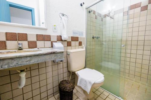 a bathroom with a toilet and a sink and a shower at Hotel Estalagem Porto Seguro in Porto Seguro