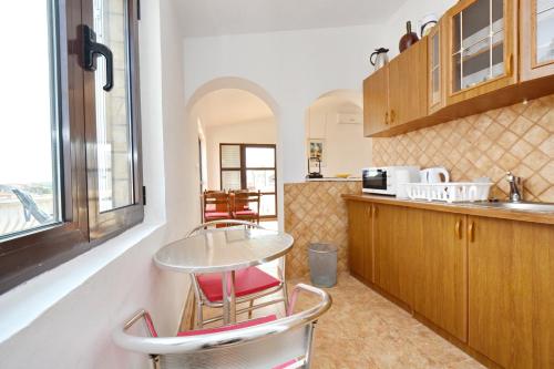 a kitchen with a table and some chairs in it at Apartment Franc in Vir