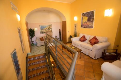 a living room with a white couch and an archway at Hotel Potenza in Naples
