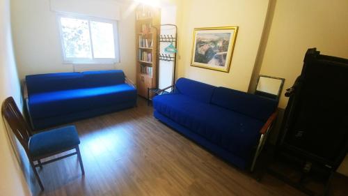a living room with a blue couch and a chair at Jerusalem Highest in Jerusalem